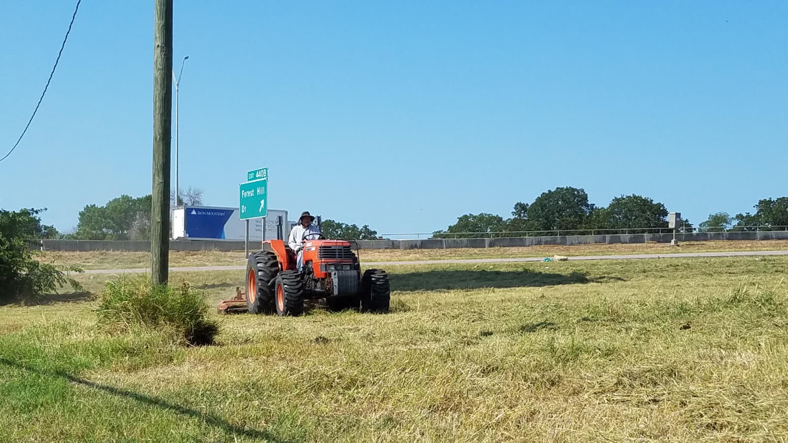Hipolito mowing on tractor